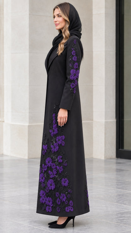 Side profile of black maxi coat highlighting purple floral sleeve and hem embroidery