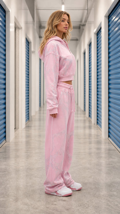 Side angle view of model wearing Light Pink two piece cropped hoodie and wide leg sweats set