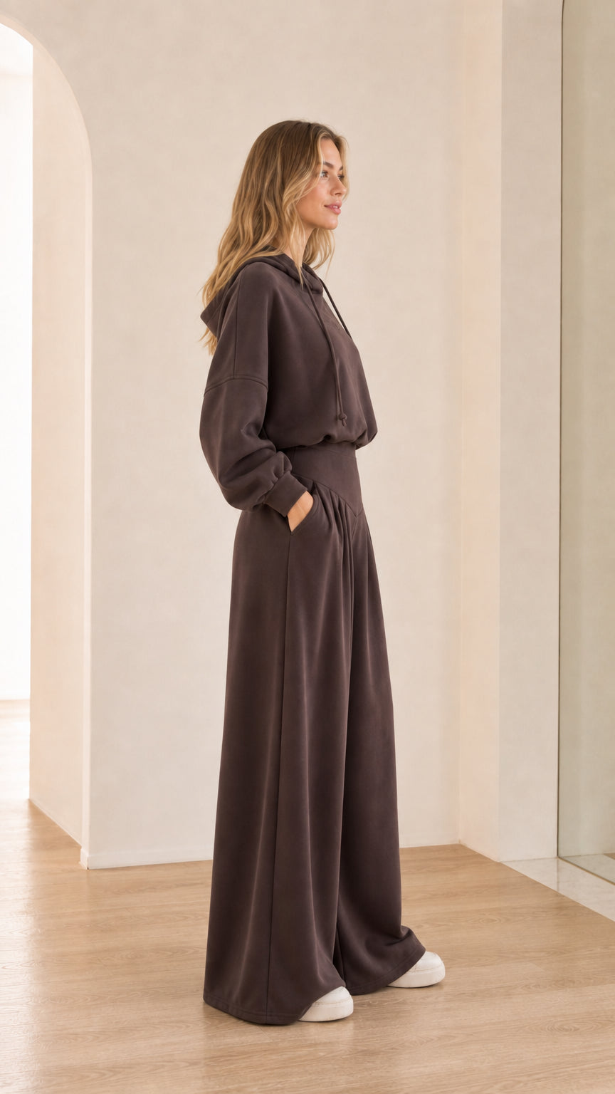 Side angle of chocolate brown pleated wide-leg trousers and hoodie set