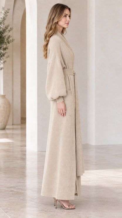 Side angle view of woman modeling beige longline knit cardigan set