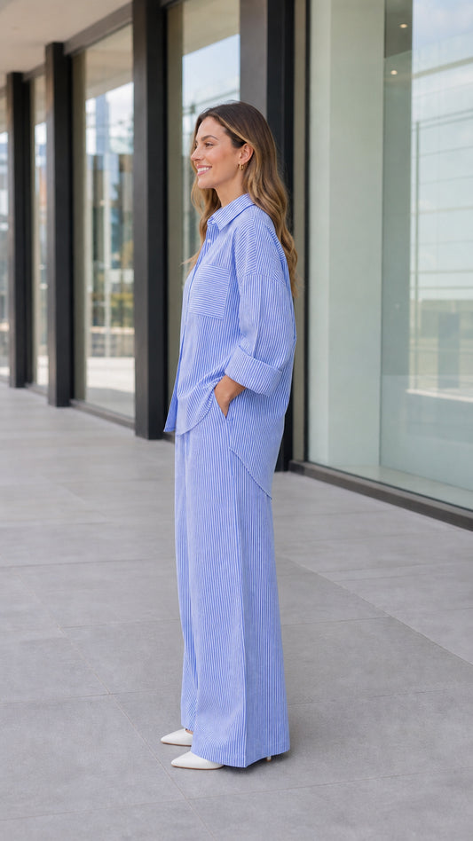 Side full-length view of woman wearing blue striped two-piece matching set