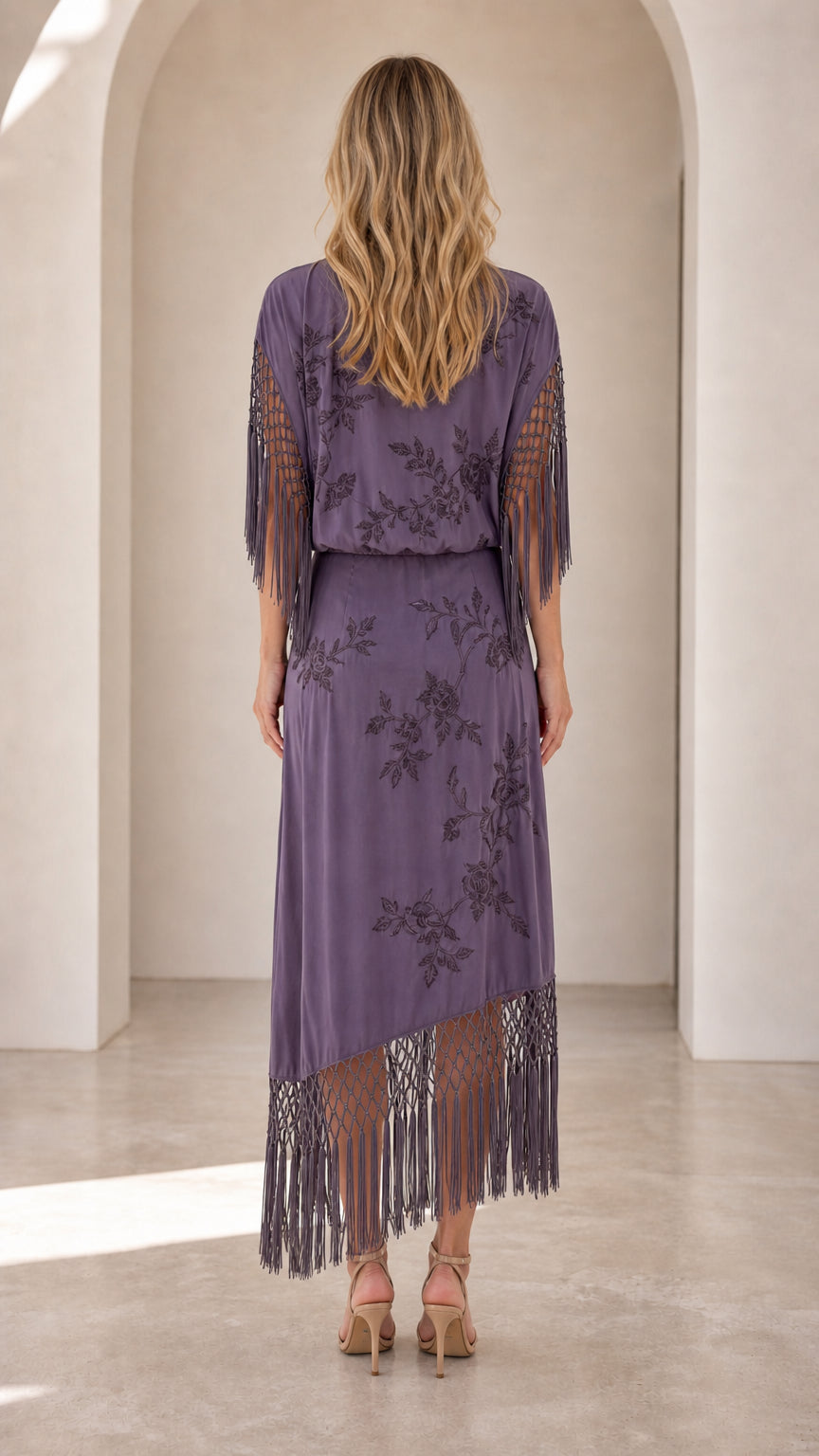 Back view of dusty purple floral maxi dress showing blouson waist and fringe detailing