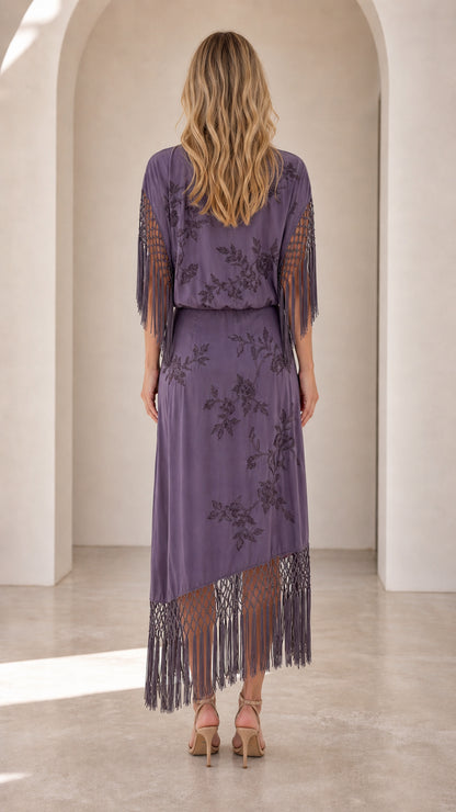 Back view of dusty purple floral maxi dress showing blouson waist and fringe detailing