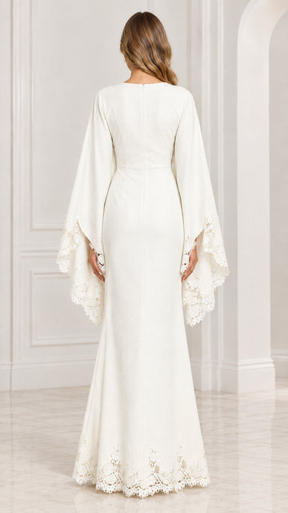 Back view of white evening dress with split cape sleeves and back zipper closure
