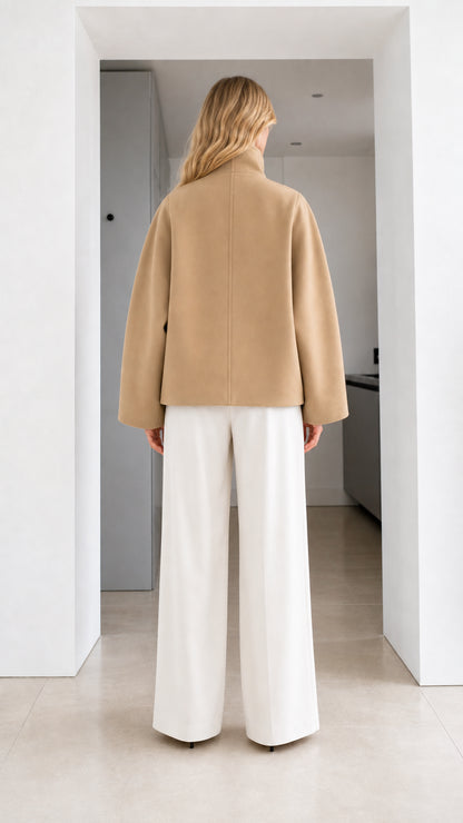 Back view of model wearing camel tailored short jacket