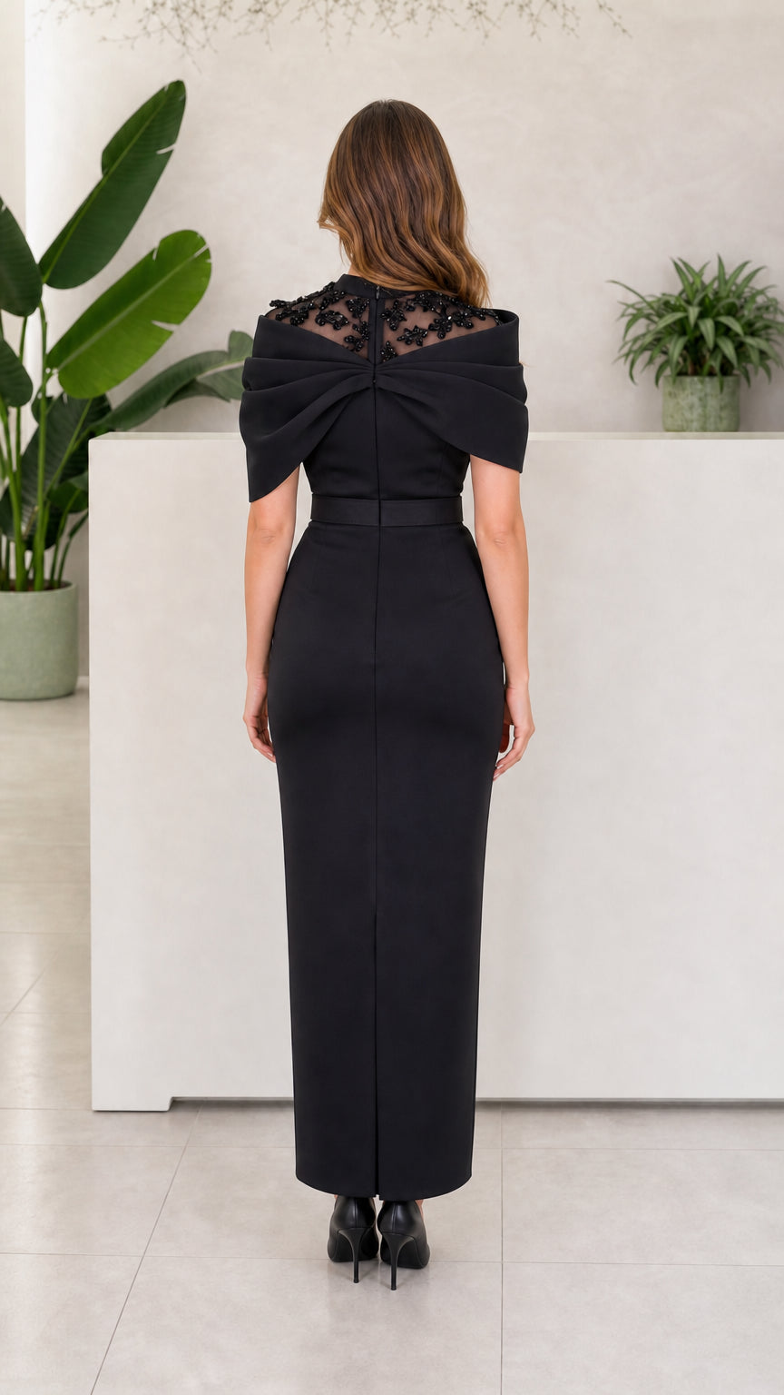 Back view of Black illusion neck column gown showing back mesh detail and clean silhouette