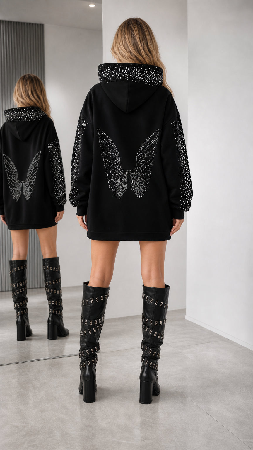 Back view of model showing large rhinestone angel wing motif on black hoodie dress