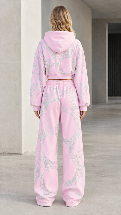 Back view of model in pink hooded cropped sweatshirt and wide-leg loungewear pants