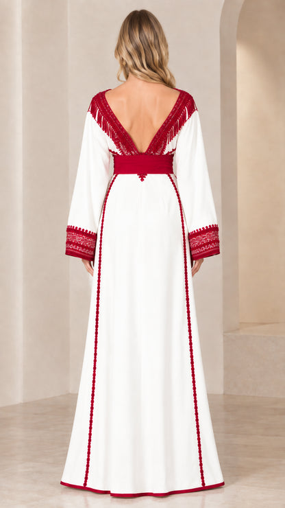 Back view of white caftan dress highlighting deep V-back with fringe and contrast trim