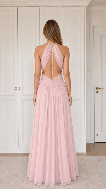 Back view of blush pink halter dress showing cutout back and vertical detailing