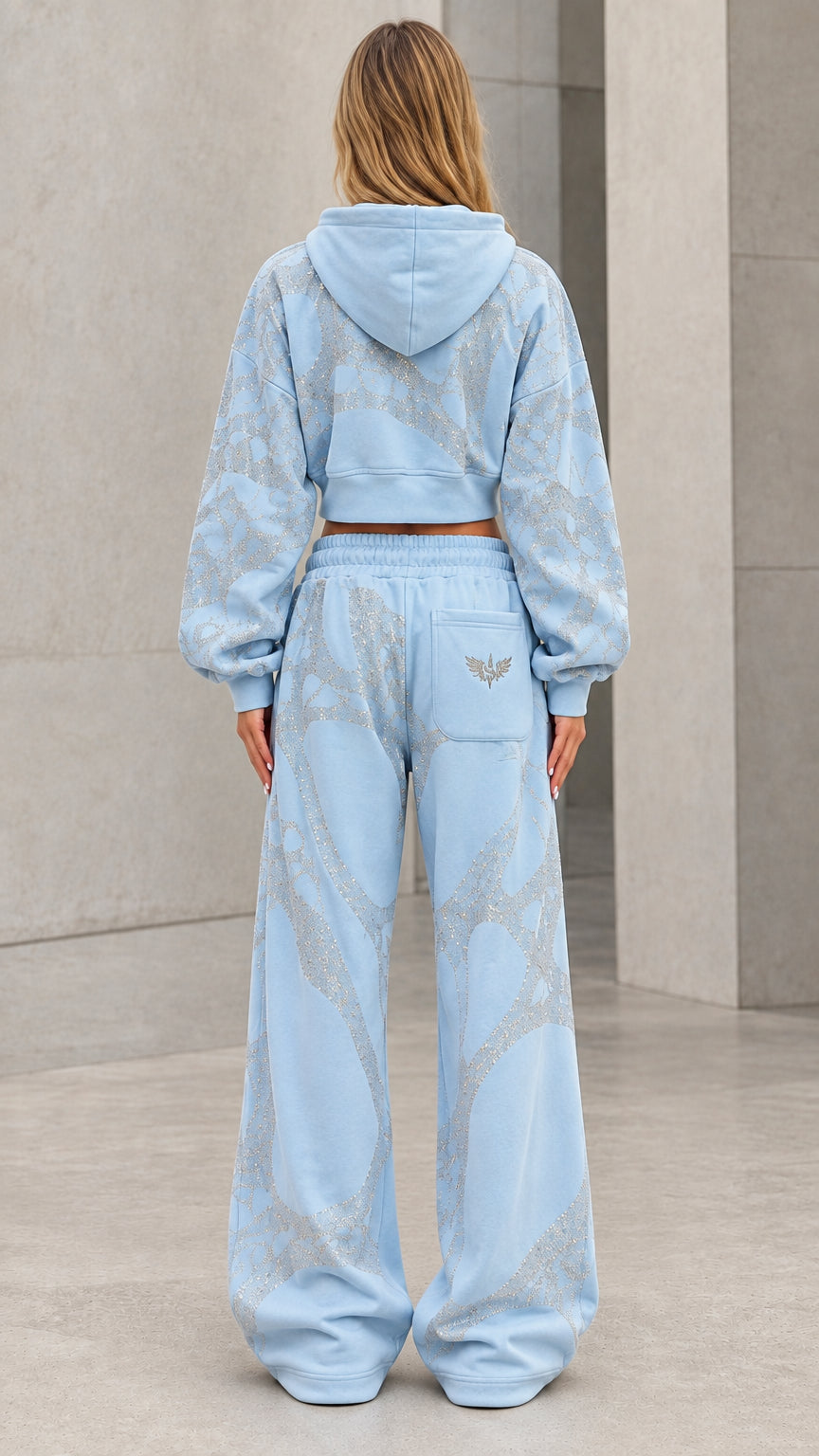 Back view of model wearing light blue hooded tracksuit set with wide-leg pants