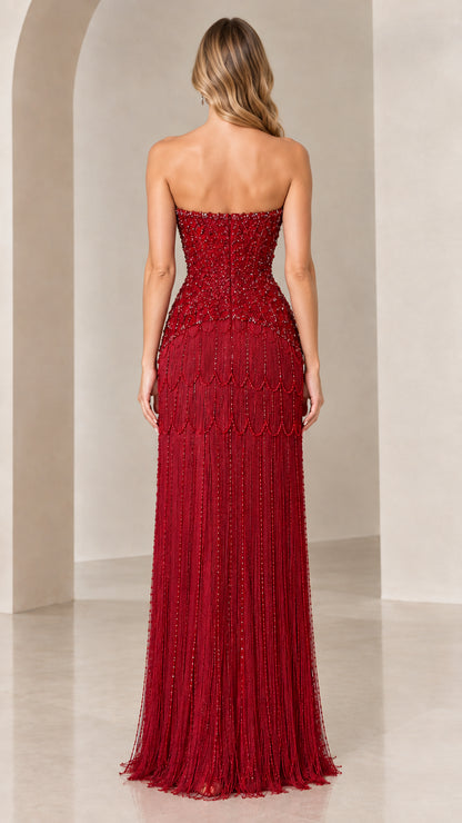 Back view of model in burgundy strapless evening gown showing fit
