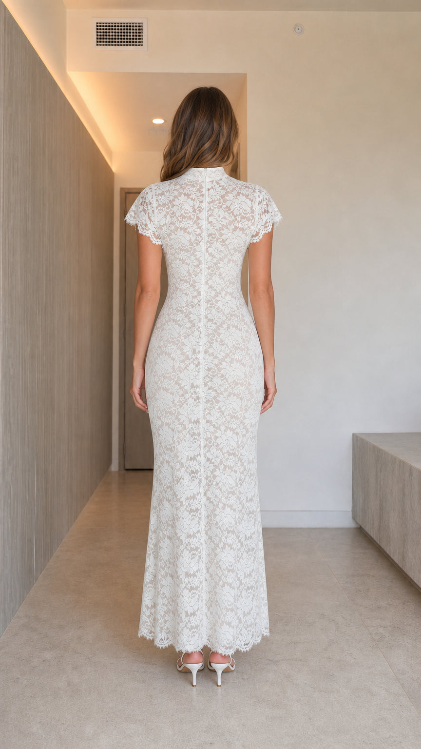 Back view of woman wearing white high neck lace column dress