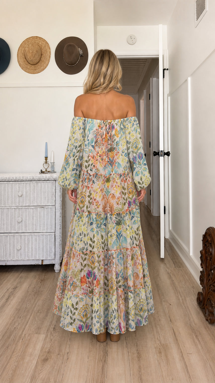Model wearing cream floral off-the-shoulder tiered maxi dress - back view