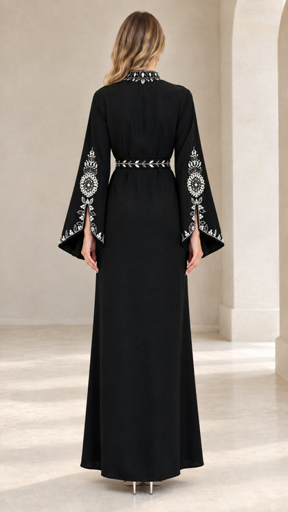 Back view of woman wearing black elegant abaya maxi dress with crystal trim