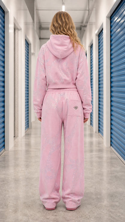 Back view of model wearing Light Pink cropped zip hoodie and wide leg sweatpants