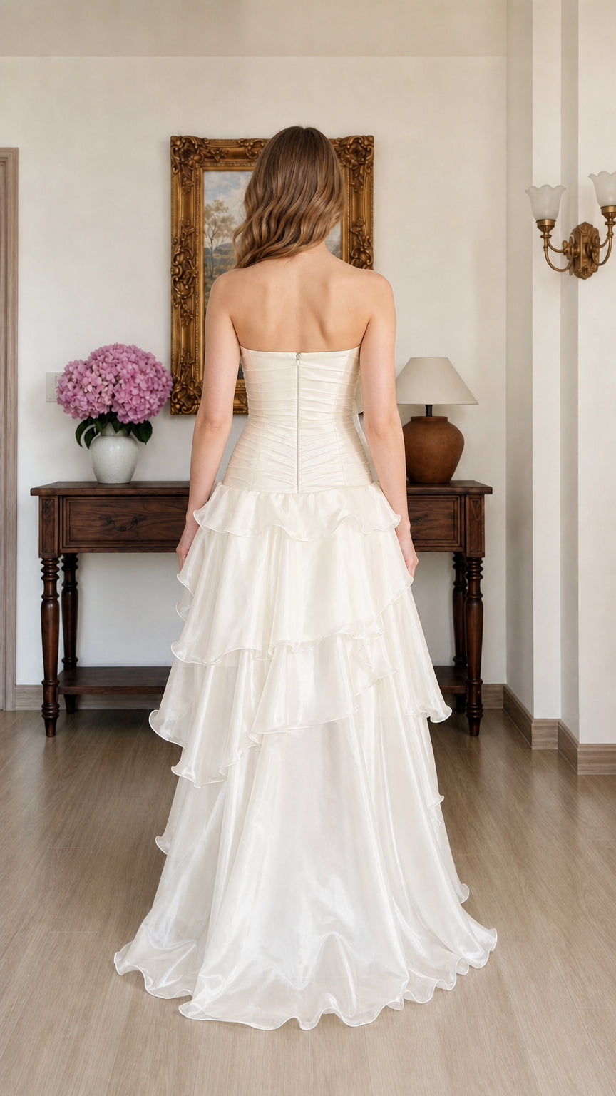 Back view of woman wearing Ivory strapless tiered ruffle evening gown