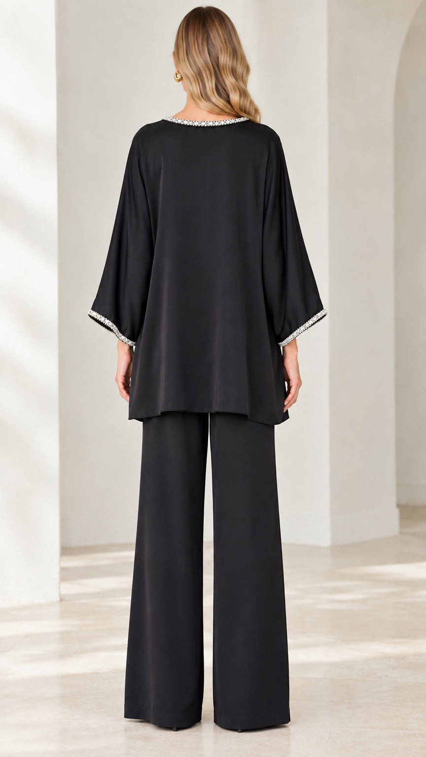 Back view of woman wearing Black flowy two-piece pant suit