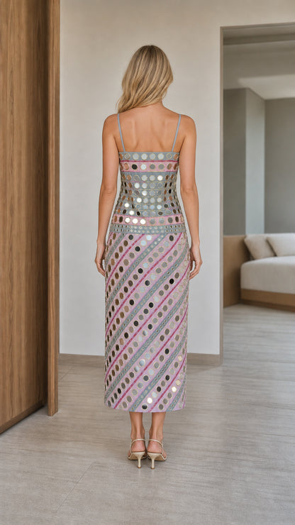 Back view of woman wearing pink mirror embroidered slip dress
