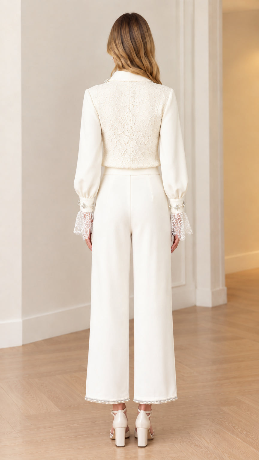 Back view of women's white lace panel blouse and wide-leg dress pants