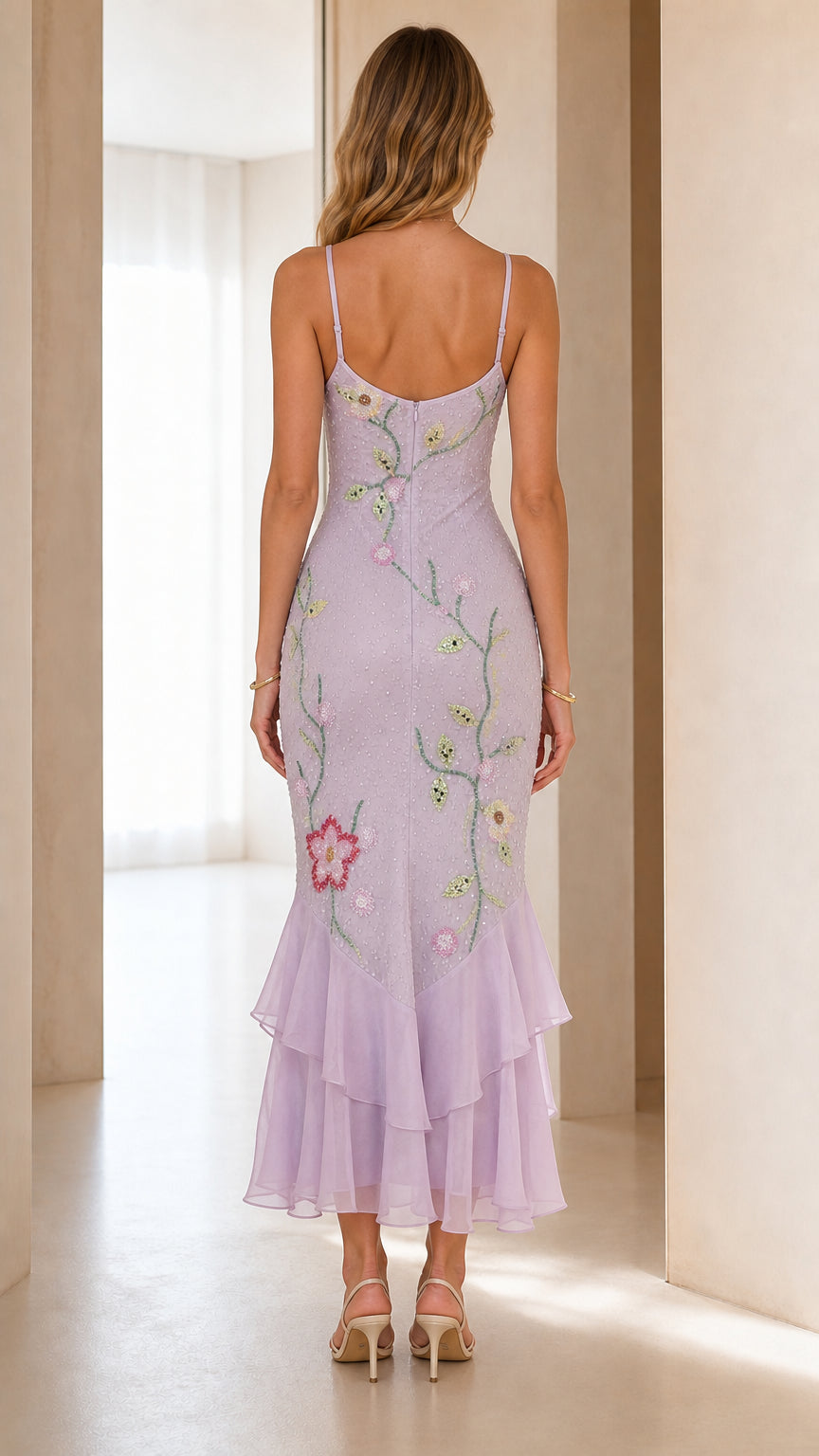 Back view of model wearing lavender spaghetti strap ruffle hem midi dress