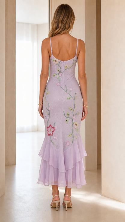 Back view of model wearing lavender spaghetti strap ruffle hem midi dress