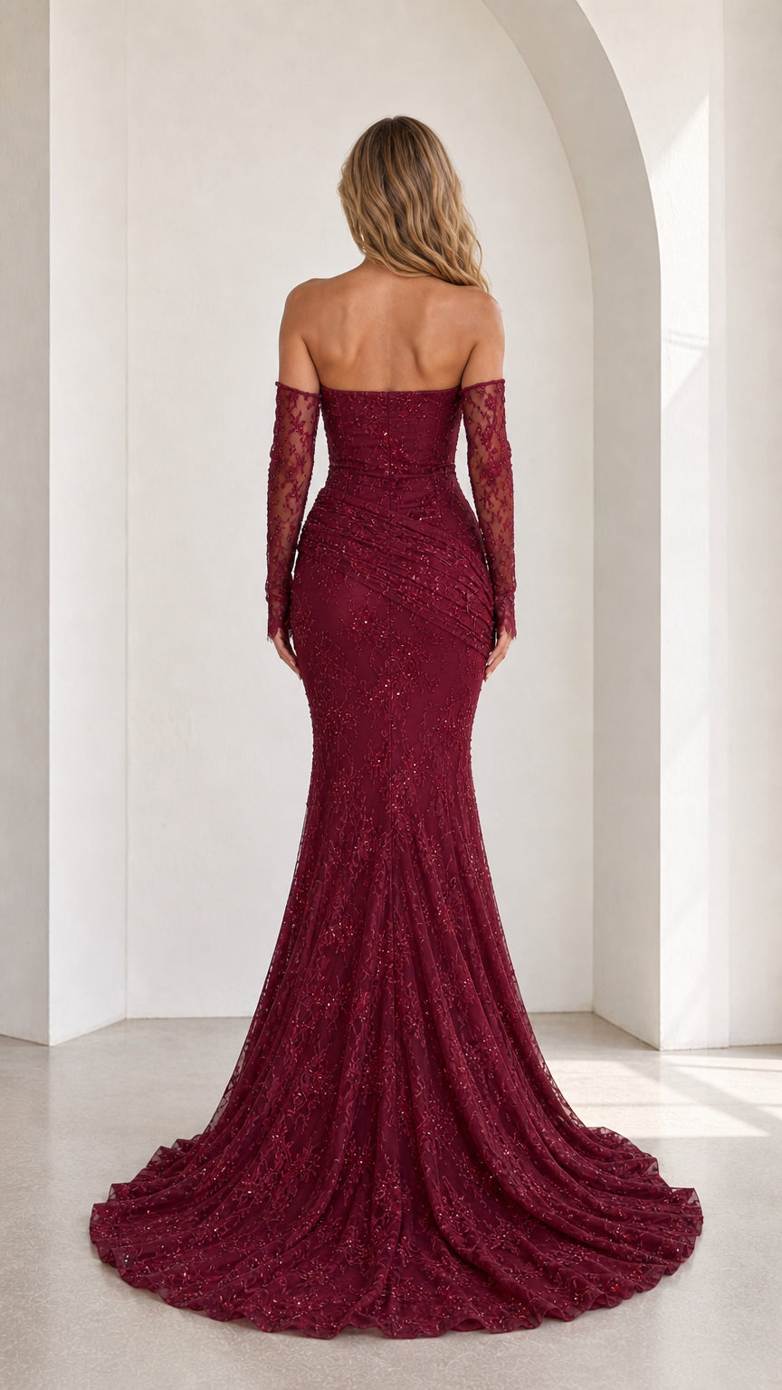 Back view of burgundy strapless evening gown showing floor-length train