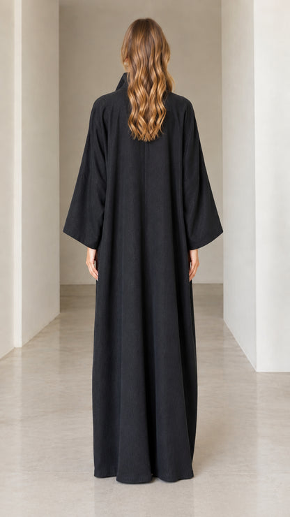 Back view of model in full-length black collared maxi dress