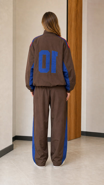 Back view of brown racing windbreaker jacket and matching track pants with large number graphic