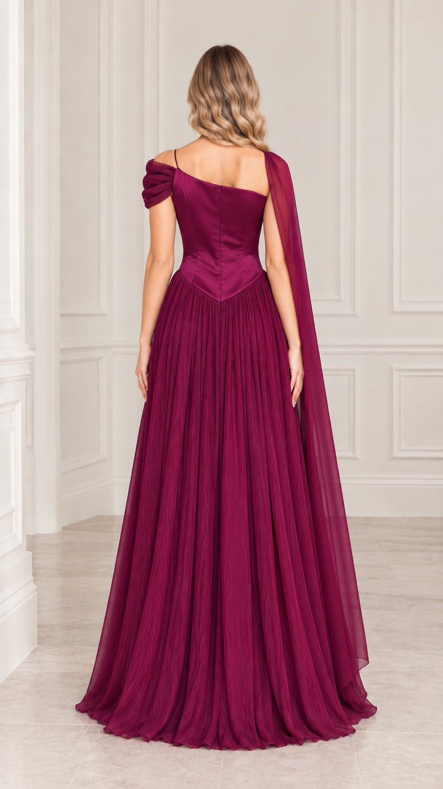 Back view of plum floor length pleated gown highlighting cape draping
