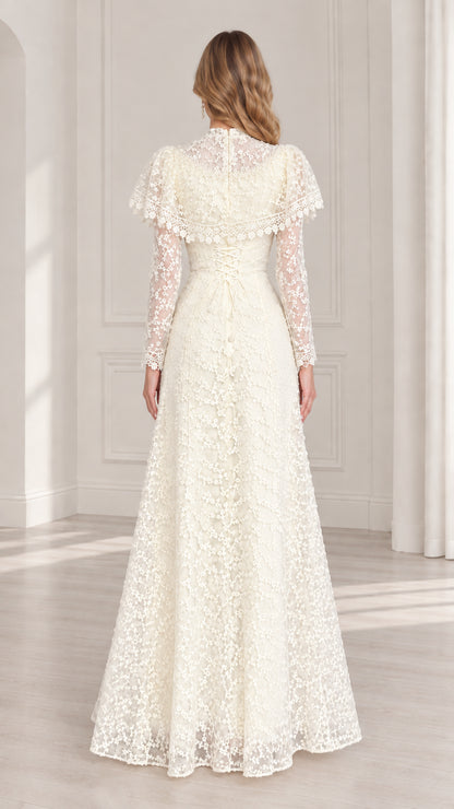 Back view of ivory lace evening maxi gown with ruffled capelet
