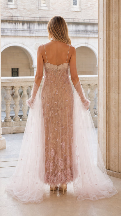 Back view of woman wearing blush pink beaded maxi evening dress