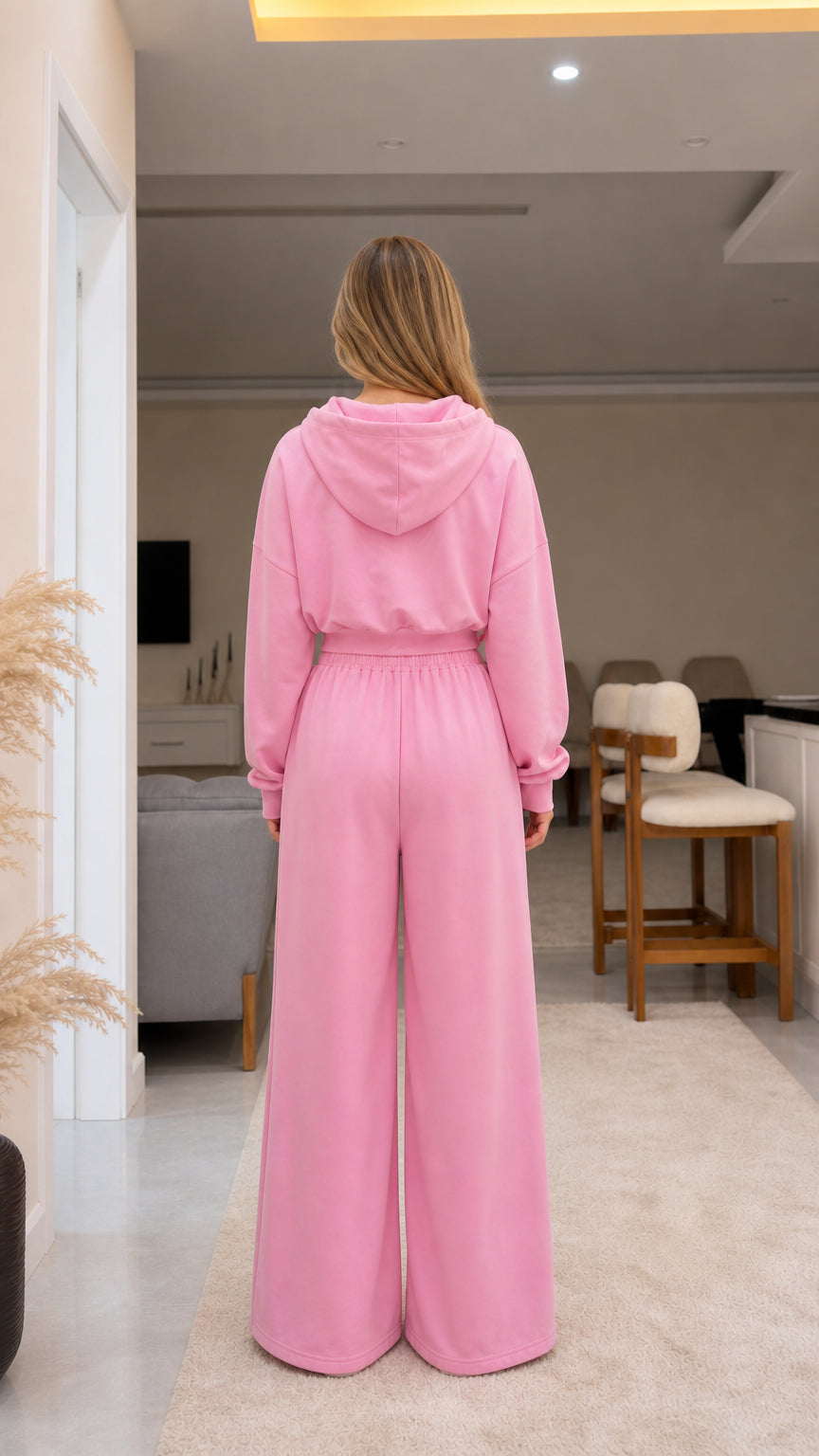 Back view of model wearing pink two-piece hoodie and wide-leg sweatpants set
