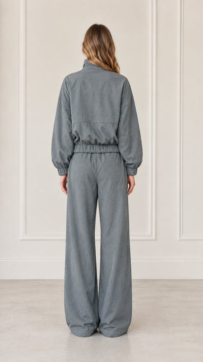 Back view of woman wearing Dusty Blue relaxed fit jacket and wide-leg pants