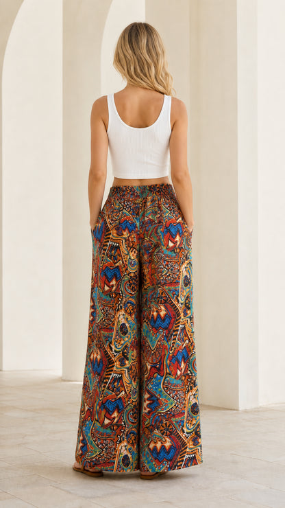 Back view of woman wearing rust multi printed wide leg pants