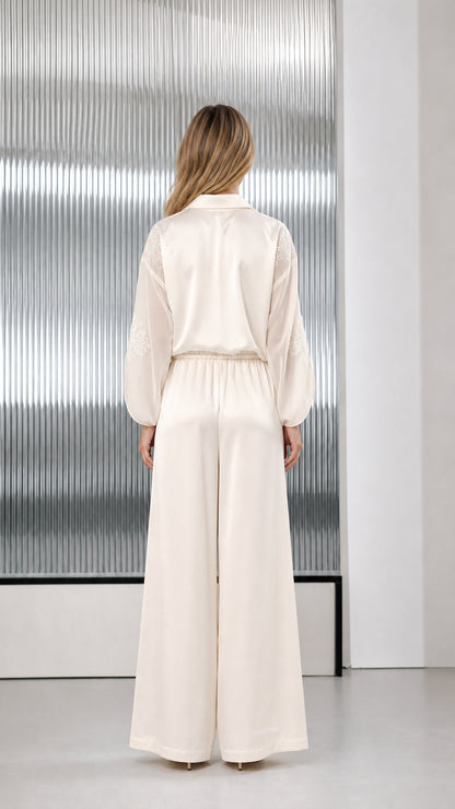Back view of ivory satin wide-leg jumpsuit showing relaxed fit