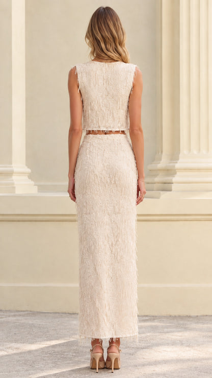 Back view of woman wearing ivory textured fringe two-piece skirt set
