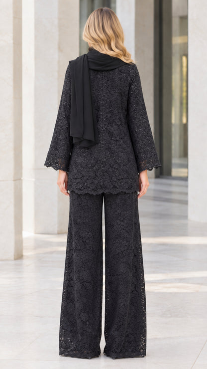 Back view of model in black sequin lace cardigan and wide-leg pants set with scarf