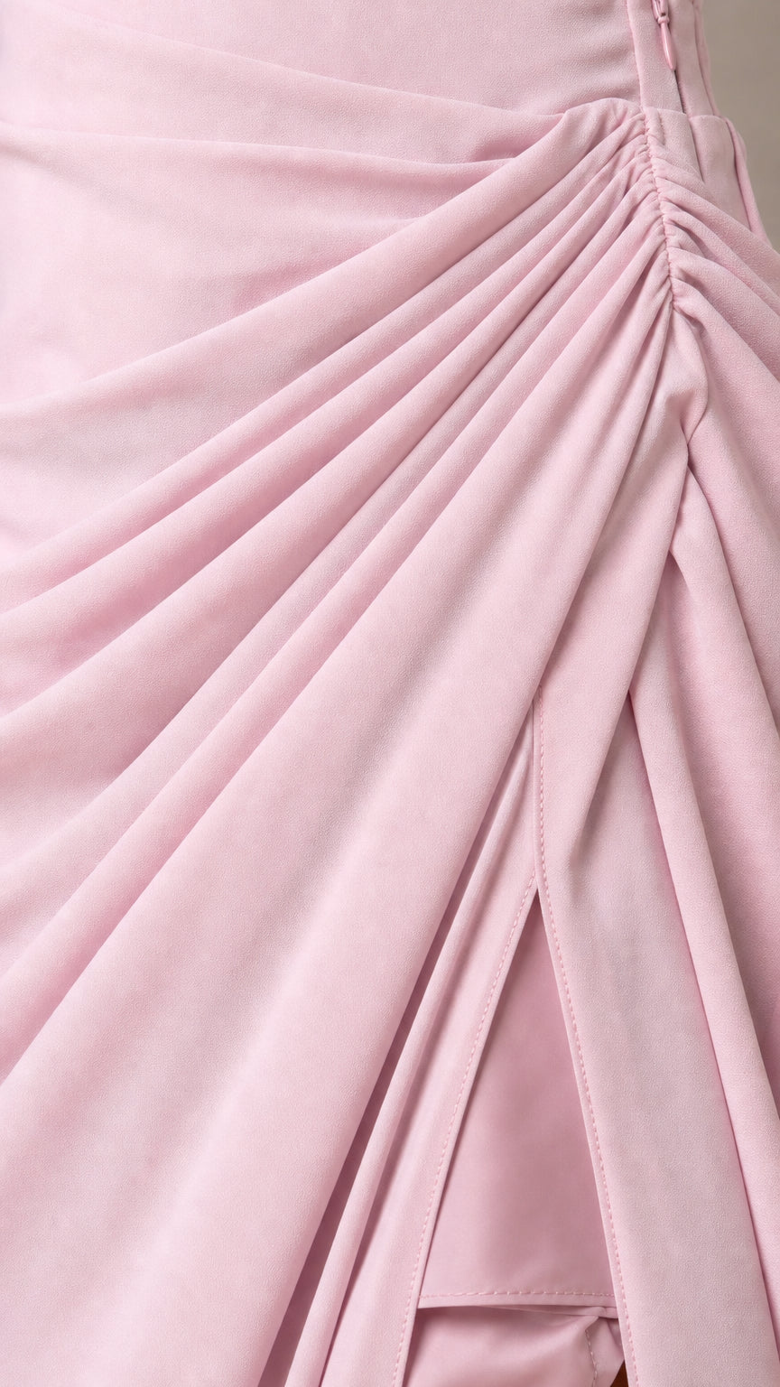 Close-up detail of draped fabric gathers and slit on Blush Pink formal gown