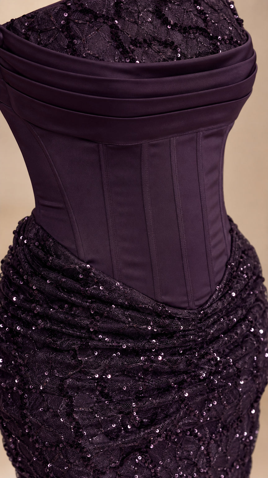 Close-up detail of the structured corset bodice and textured sequin skirt