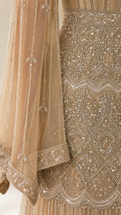 Close-up detail of delicate hand-beading, sequins, and sheer sleeve trim