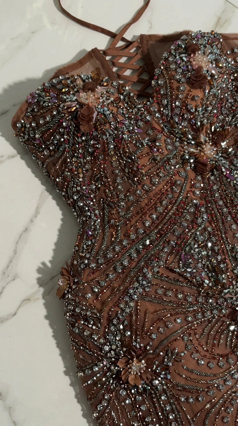 Detailed close-up of lace-up back and intricate beadwork with floral accents