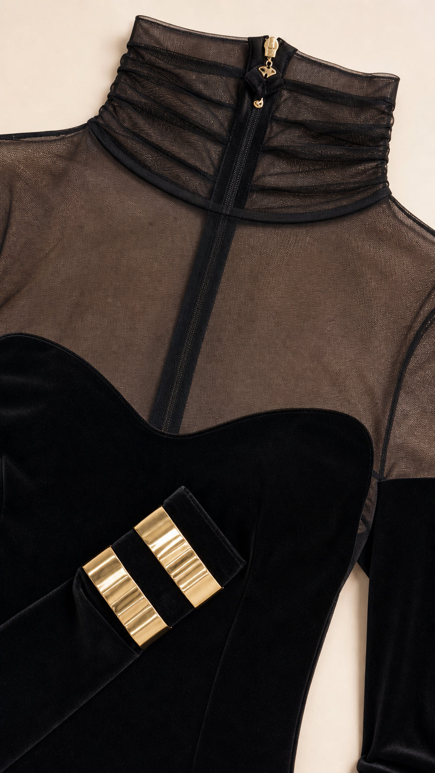 Close-up detail of sheer mock neck and gold wrist hardware accents