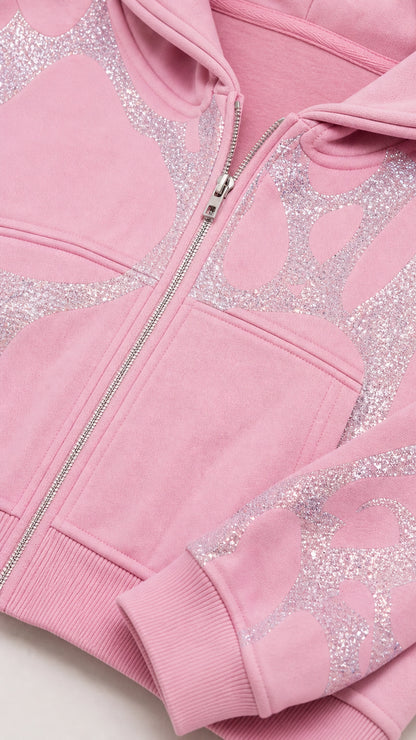 Close-up detail of Light Pink cropped zip hoodie showing glitter graphic and zipper hardware