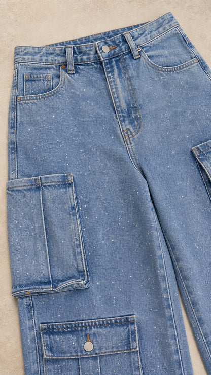 Close-up detail of Light Blue denim fabric, stitching, waist, and tiered cargo pockets
