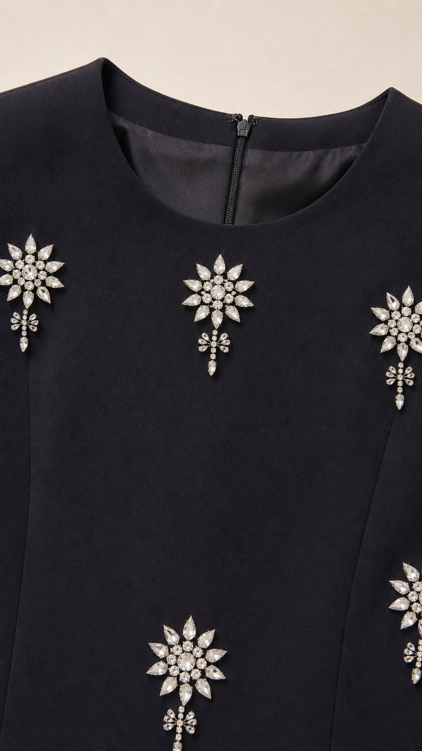 Close up of neckline and sparkling crystal rhinestone floral motif embellishments