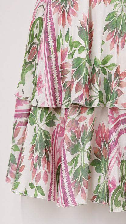 Close-up detail of tiered hemline and pink and green floral print fabric