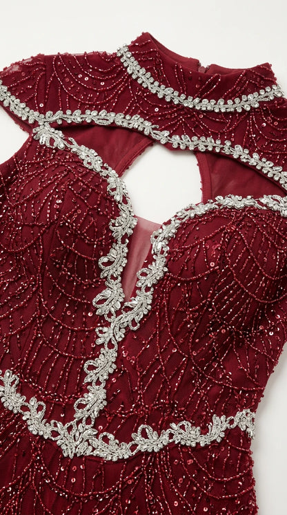 Close-up detail of silver crystal embroidery, beadwork, and keyhole cutout on burgundy dress