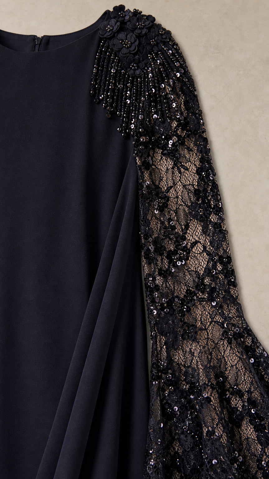 Close-up detail of shoulder floral beading and sheer lace flared sleeve