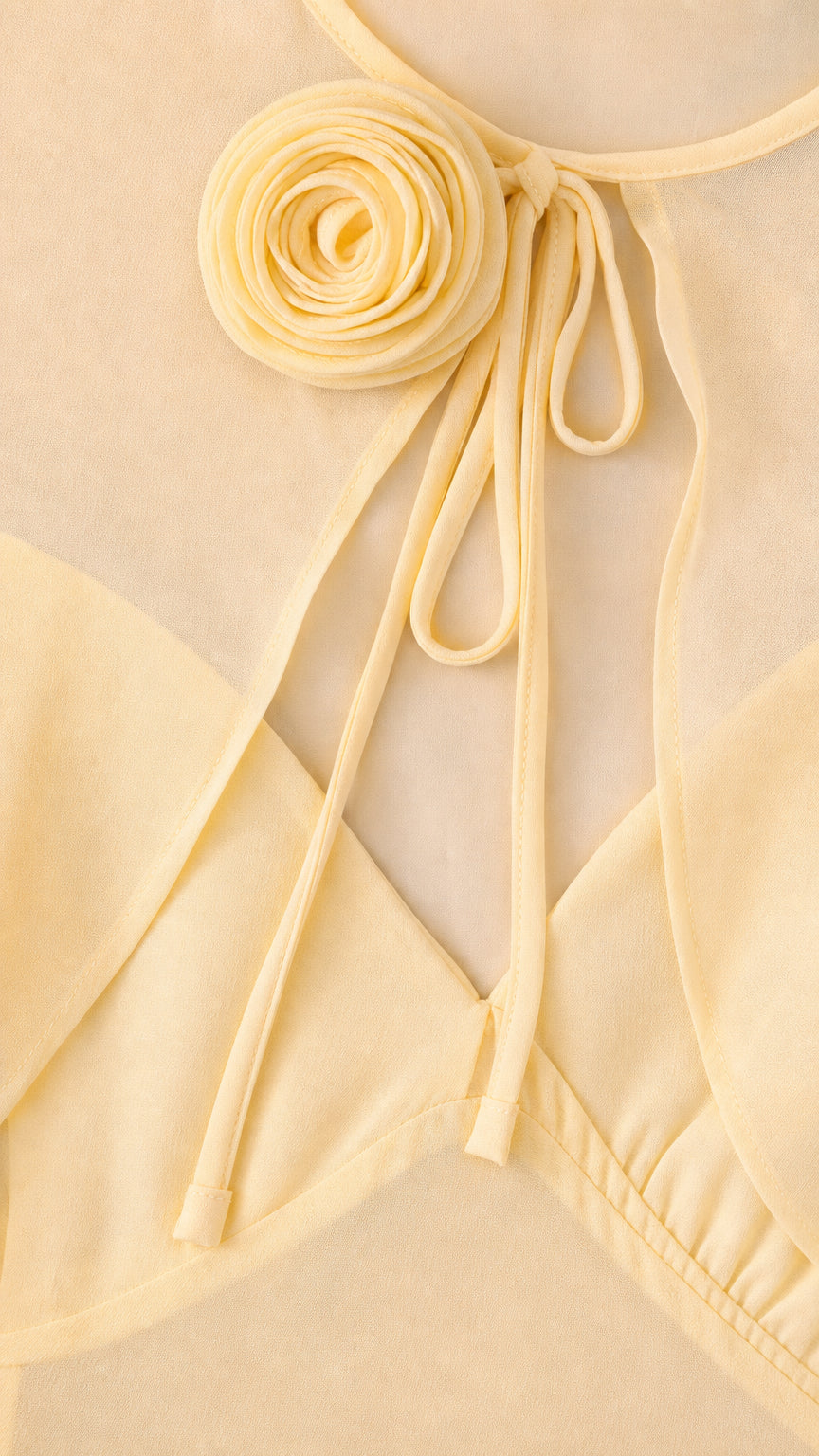 Close-up detail of Butter Yellow 3D fabric flower rosette and tie neckline
